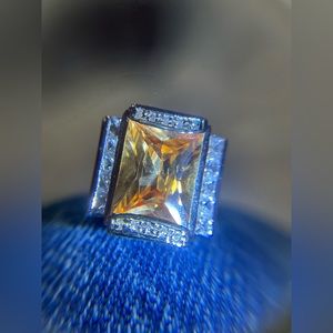 Silver tone ring with an orange peachy color rectangle stone size 6